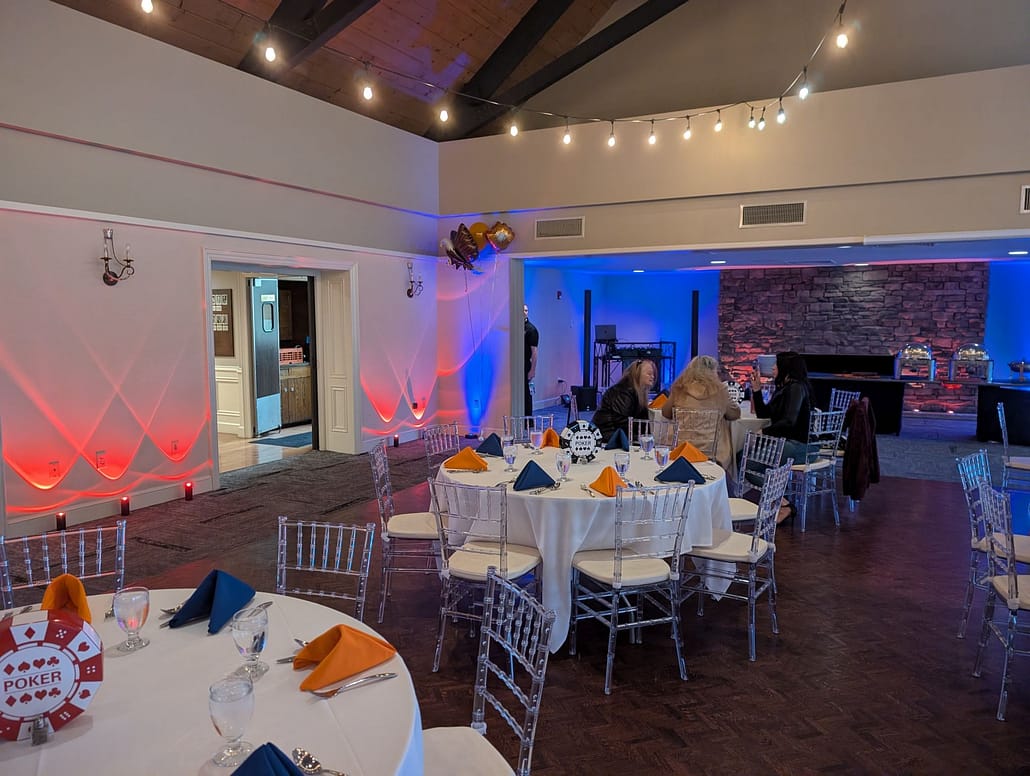 Wide-angle view of a corporate gala ballroom featuring custom brand-matched uplighting and professional event production