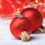 engagement ring in front of Christmas presents