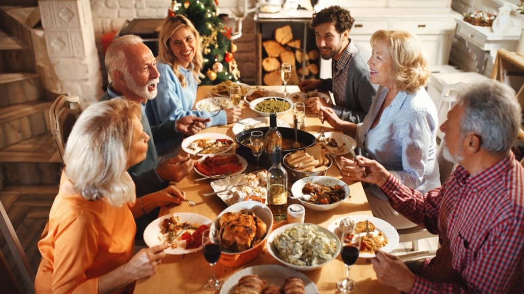Engaged couple celebrating holiday family gathering